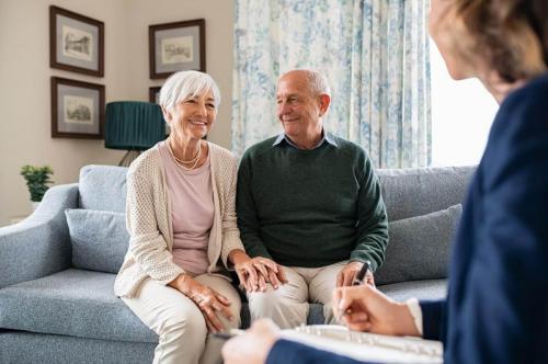 loan officer visiting seniors at home discussing reverse mortgages